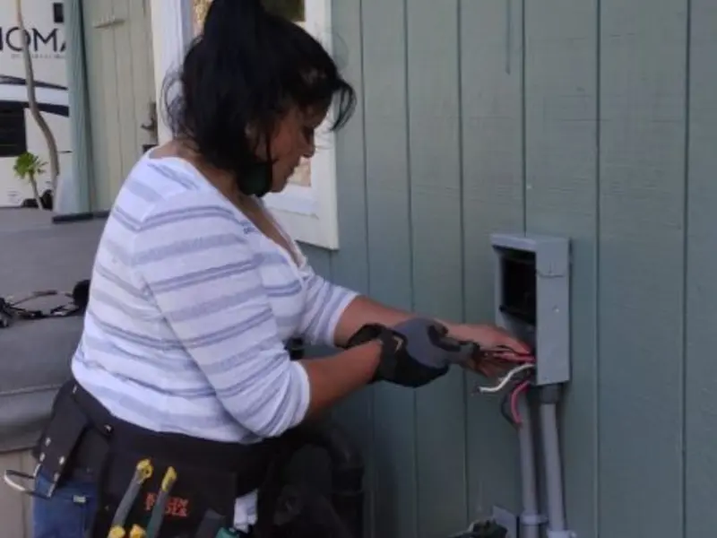 Licensed electrician wiring an exterior subpanel in Forsyth