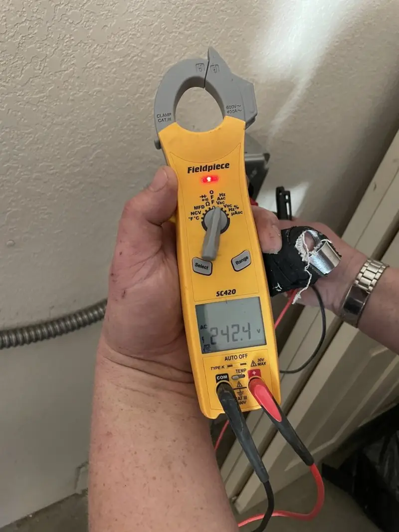 Voltage testing with clamp meter during Whole House Surge Protector in Forsyth